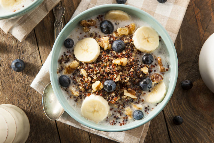 bowl of healthy porridge with bananas and blueberries in it