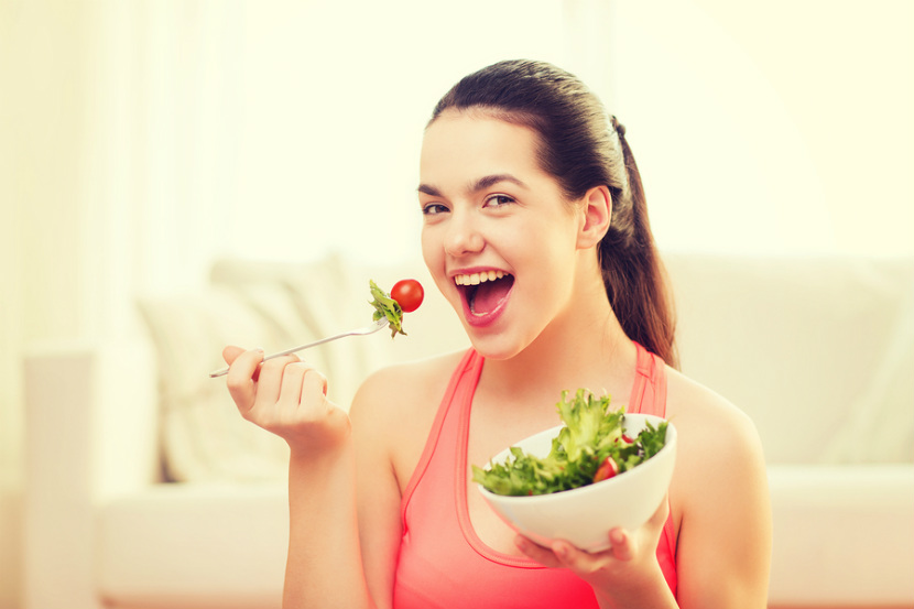 young woman eating a salad