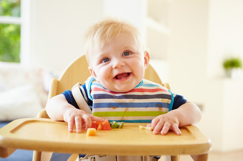 baby eating at his high chair
