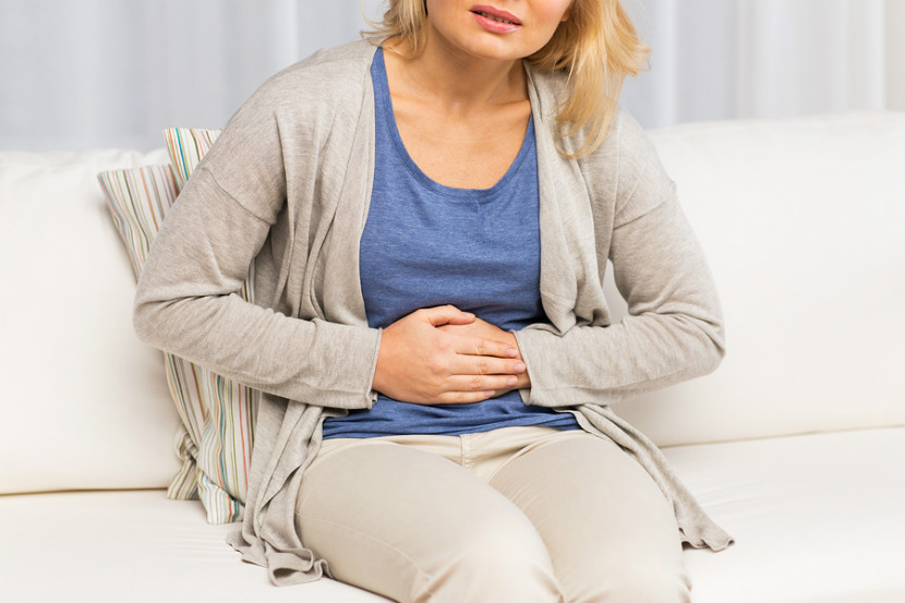 woman holding stomach in discomfort
